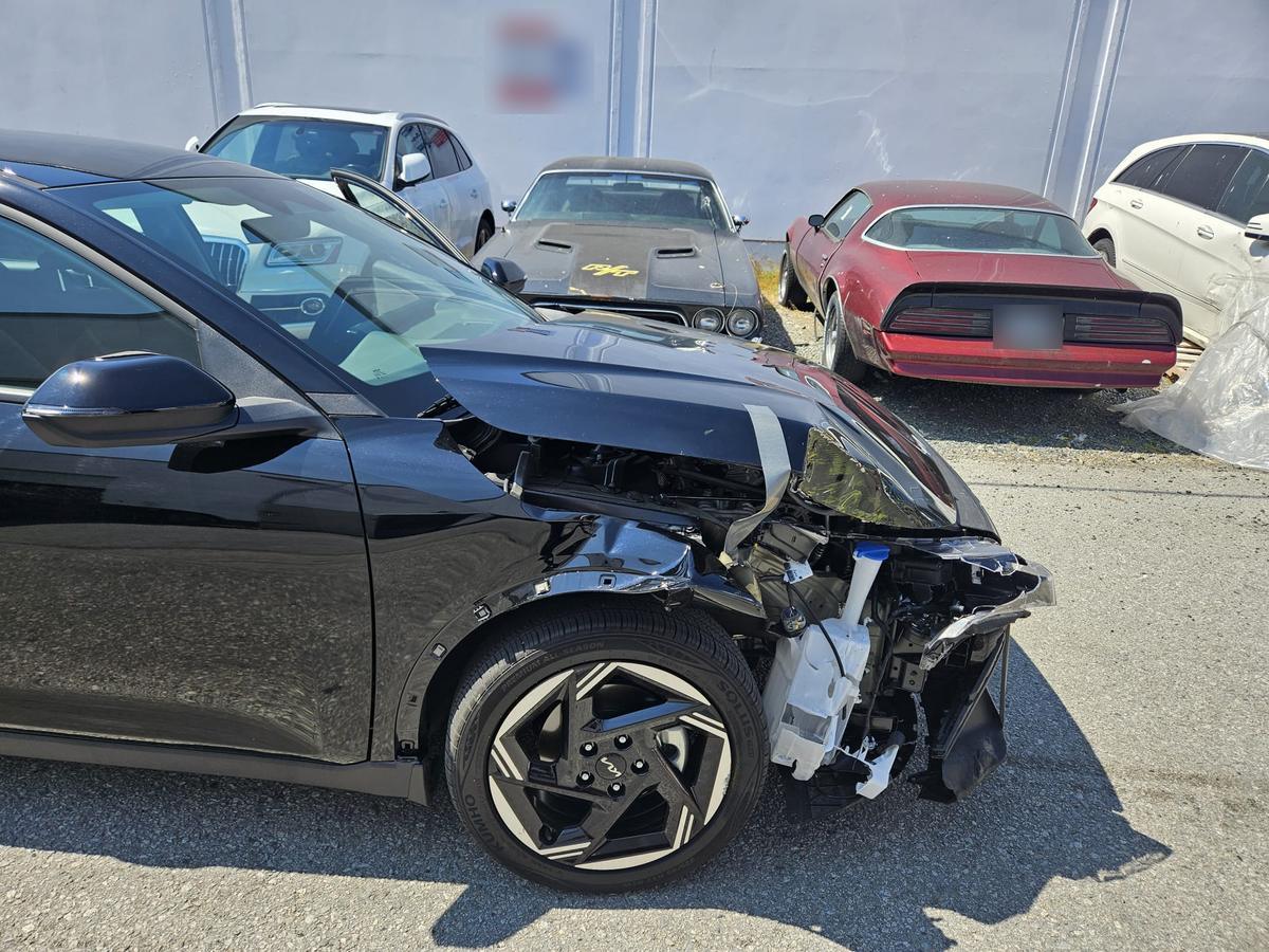 Front of a black sedan crushed after a collision